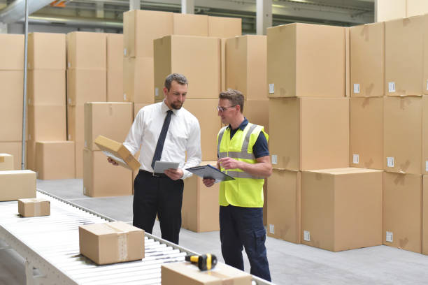 Worker and Manager in warehouse in manufacturing sector