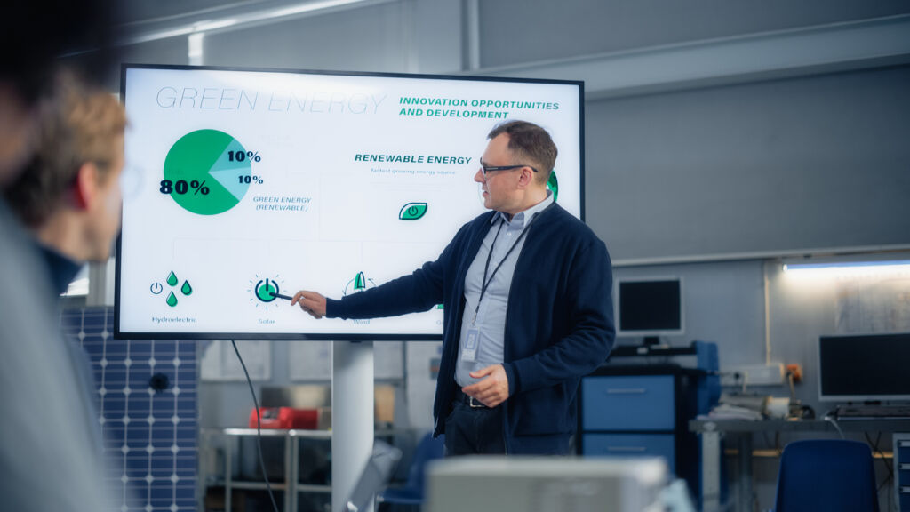 worker explaining renewable energy and energy management in manufacturing