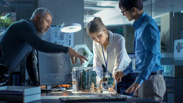 Team of Computer Engineers Lean on the Desk and Working with IT Department