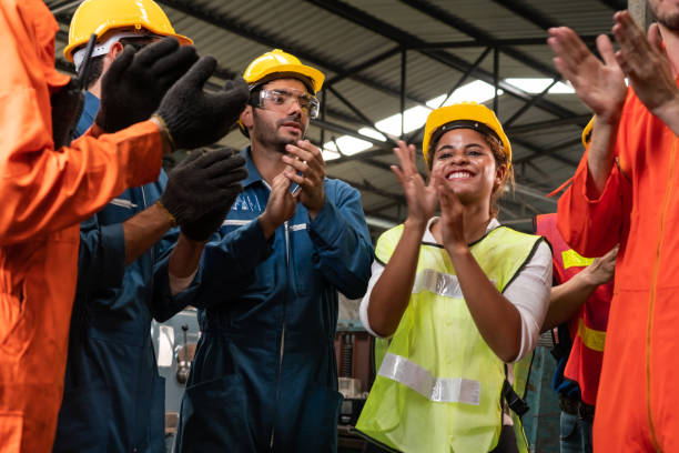 manufacturing skillful worker celebrate success in the factory recognizing and rewarding Achievements