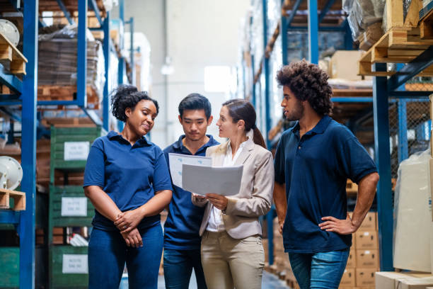 Female supervisor giving training to employees in warehouse and development opportunities