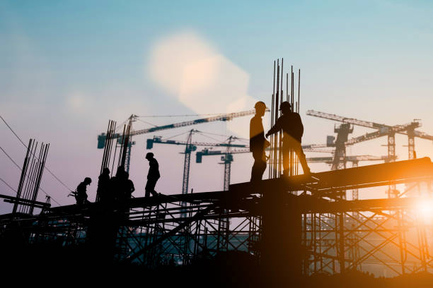 Silhouette of engineer and construction team working at site