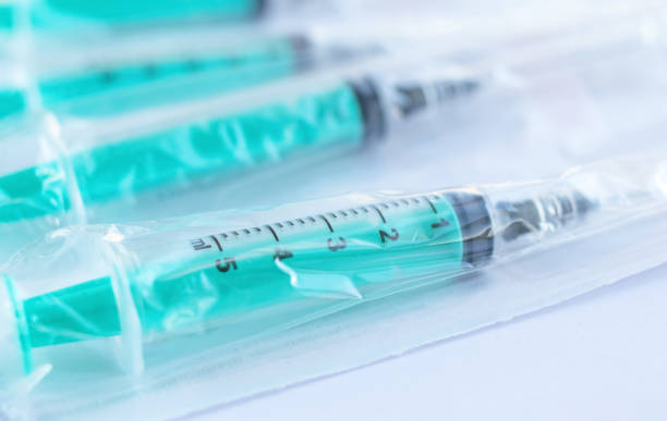 Medical disposable syringes with needles in manufacturing
