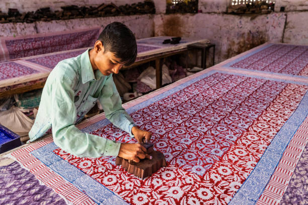 Young man working in a block printing factory