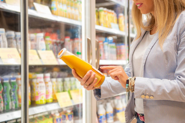 Woman reading ingredients information on fiber bottle's etiquette