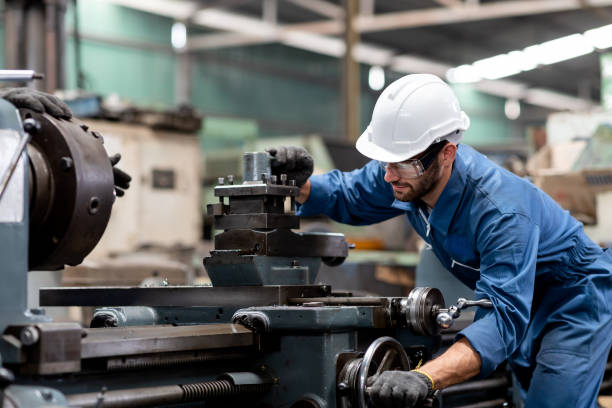 Industrial engineer worker working with manufacturing machinery in the factory