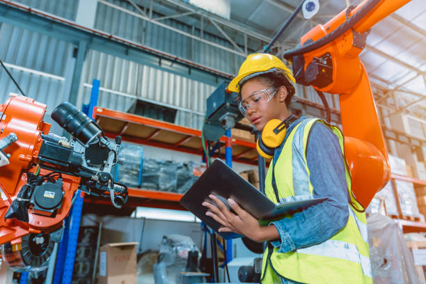 Engineer smart woman worker working programing robotic welding machine