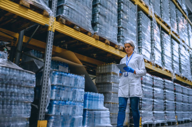 A woman working at a plastic bottle warehouse