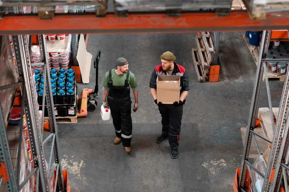 Warehouse workers handling goods in a temperature-controlled facility — highlighting the role of cold chain logistics in food supply chain optimization to reduce waste