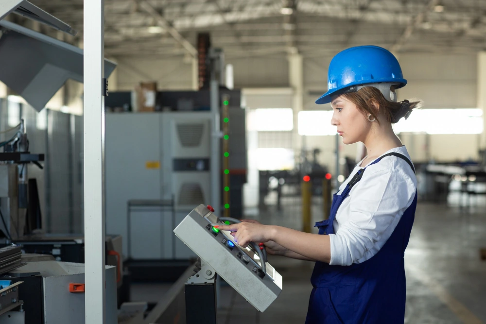 A machine operator monitors real-time data on a smart manufacturing dashboard surrounded by advanced equipment, illustrating the future of machining and intelligent manufacturing systems