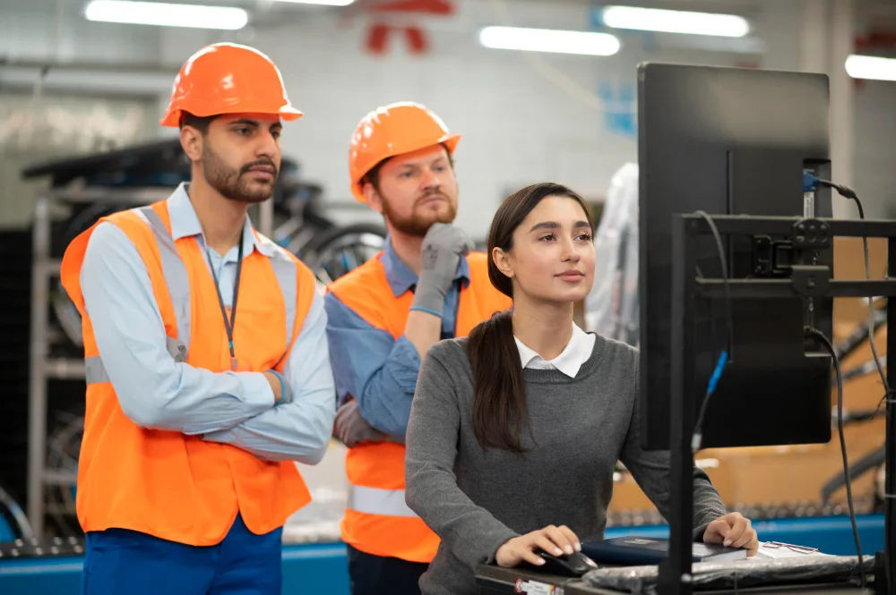 Technicians participating in advanced manufacturing training on factory floor