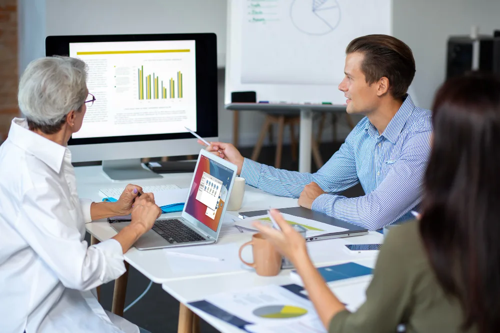 Team reviewing manufacturing business development strategies and ROI data in a planning session
